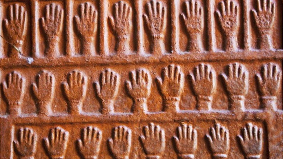 Hands commemorating women who killed themselves on the pyre of their husbands on the walls of the Mehrangarh Fort in Jodhpur, Rajasthan, India . (