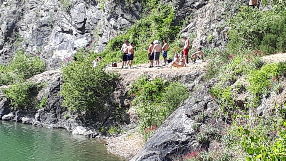 People near the quarry's water