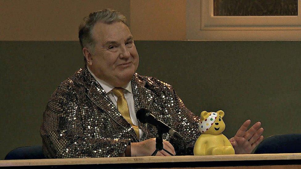 A picture of Russell Grant in a gold jacket