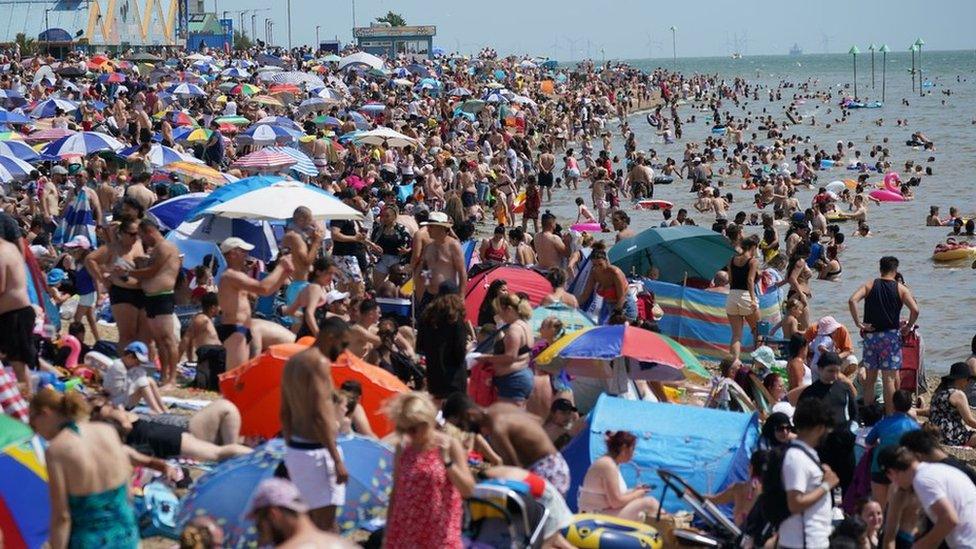 People relax on the beach at Southend-on-Sea on the Thames Estuary in Essex