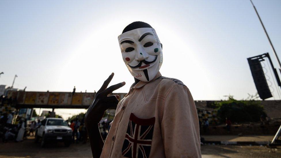 A Sudanese protester wears a Guy Fawkes mask outside the army headquarters in Khartoum on May 6, 2019.