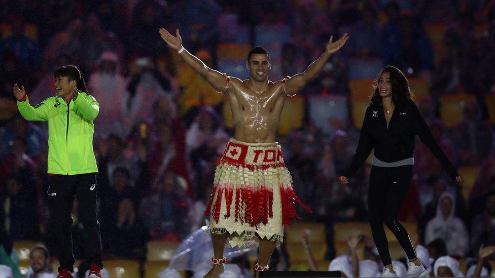 Pita Taufatofua of Tonga jumps on stage during the Closing Ceremony on Day 16 of the Rio 2016 Olympic Games