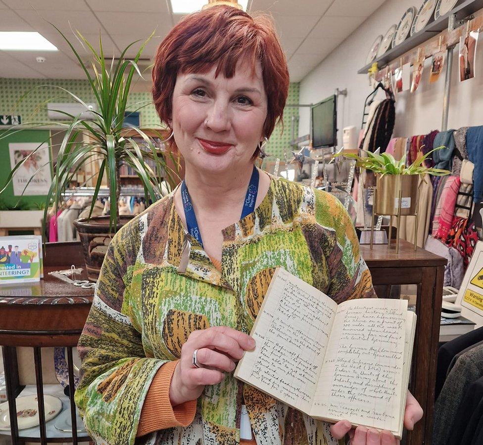 Tracey Chippett with a World War Two diary at a charity shop in Harlow