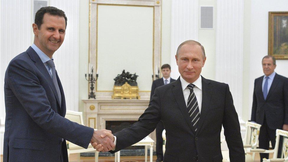 Russian President Vladimir Putin (R) shakes hands with Syrian President Bashar al-Assad during a meeting at the Kremlin in Moscow, Russia