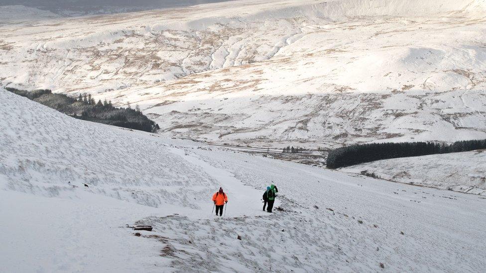 Two walkers in the snow on Pen Y Fan in the Brecon Beacons