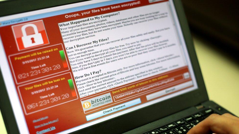 A programmer shows a sample of a ransomware cyberattack on a laptop in Taipei, Taiwan