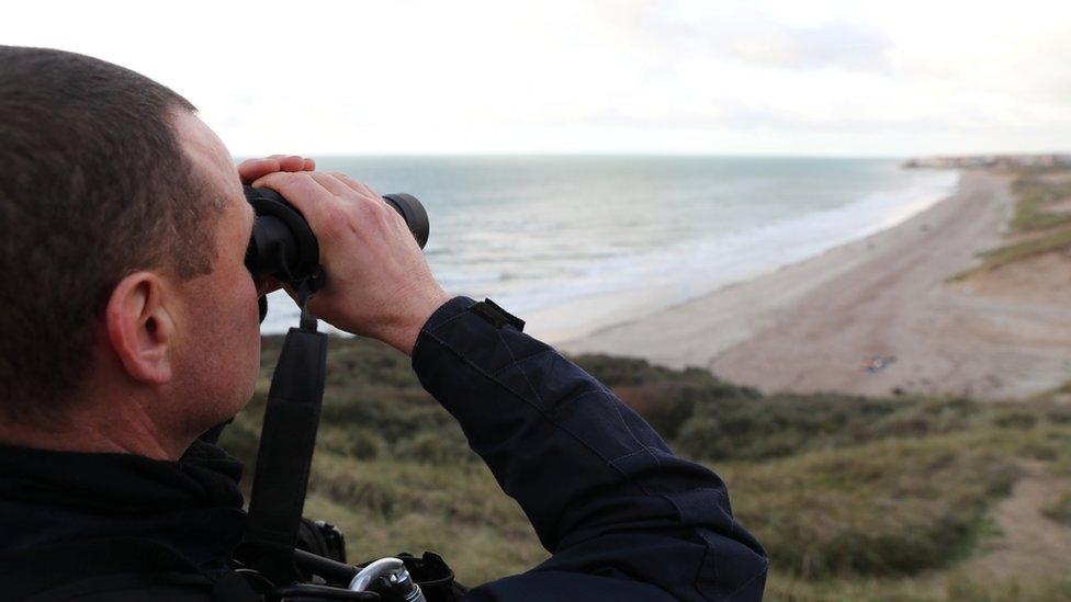 French police patrol the Slack dunes, the day after 27 migrants died