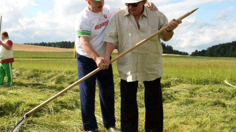 President Alexander Lukashenko and French actor Gerard Depardieu (right) hold a hand scythe. Photo: 22 July 2015