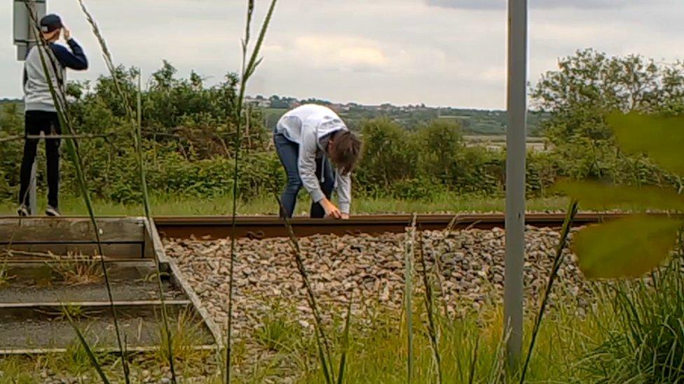 Two boys on the train tracks