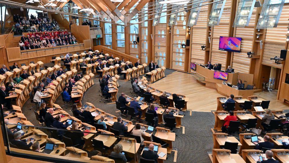 Wide shot of MSPs in the Scottish Parliament chamber 