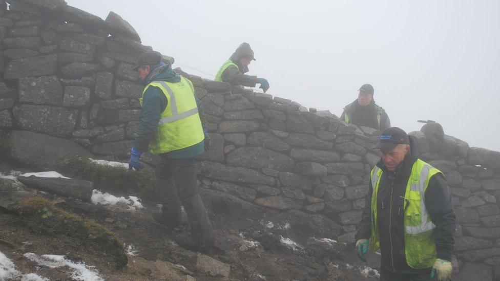 Norman McComb, Martin Stevenson and brothers Brian and Andrew Rooney working on the wall close to the summit of Slieve Donard