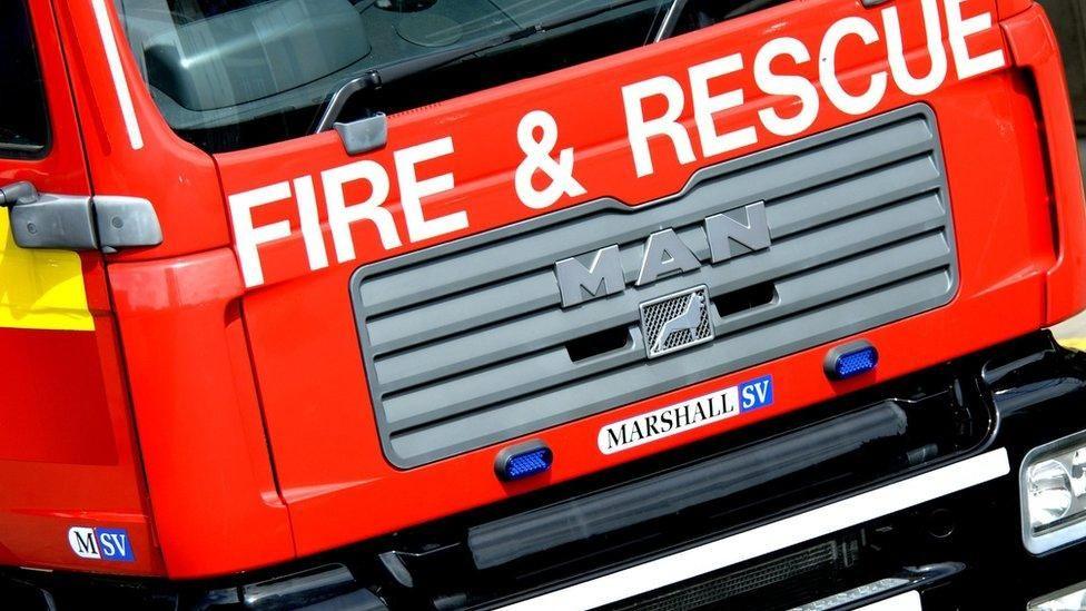 the words fire and rescue are spelled out along the front of a red Marhsall SV fire engine, 