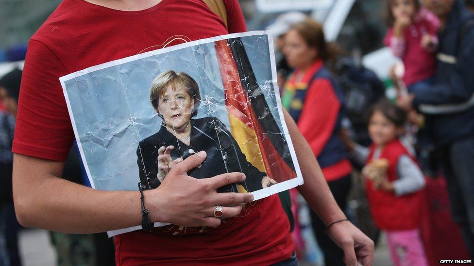 Syrian migrant holds picture of German Chancellor Angela Merkel, 5 September 2015