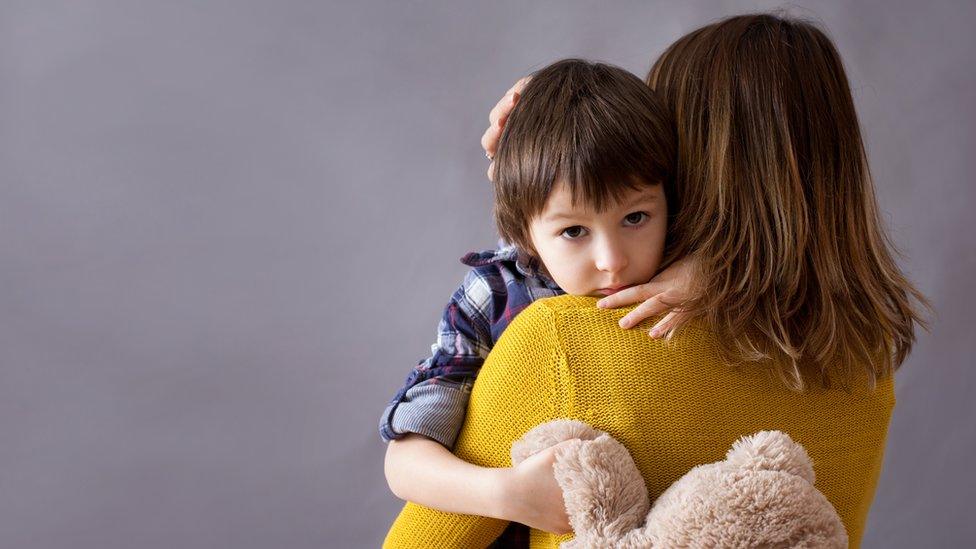 Child being comforted by his mother