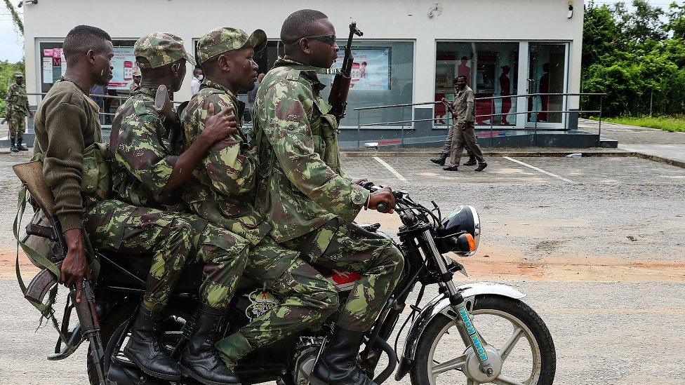 Four soldiers riding a motorbike in Palma