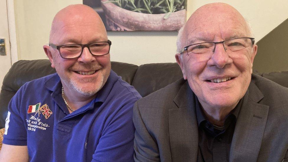 Jeremy (left) sits on sofa with his dad David (right)