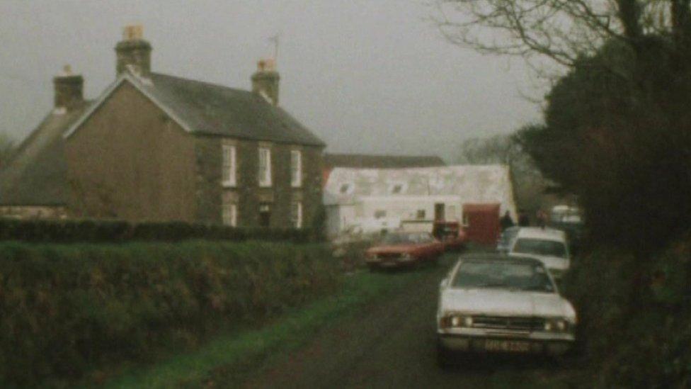 Farmhouse with 1970s cars in front