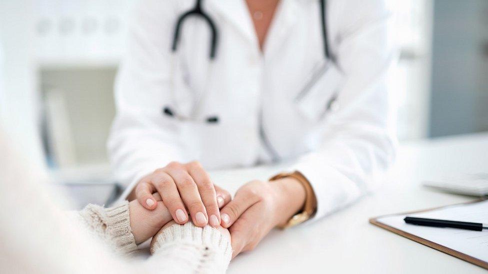 Female doctor with patient, file pic