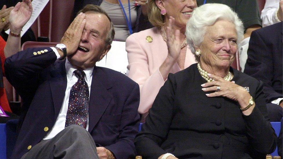 Former US President George Bush (L) waves, as he is accompanied by former US First Lady Barbara Bush, during the evening session of the 2000 Republican National Convention in Philadelphia's First Union Center 31 July, 2000.