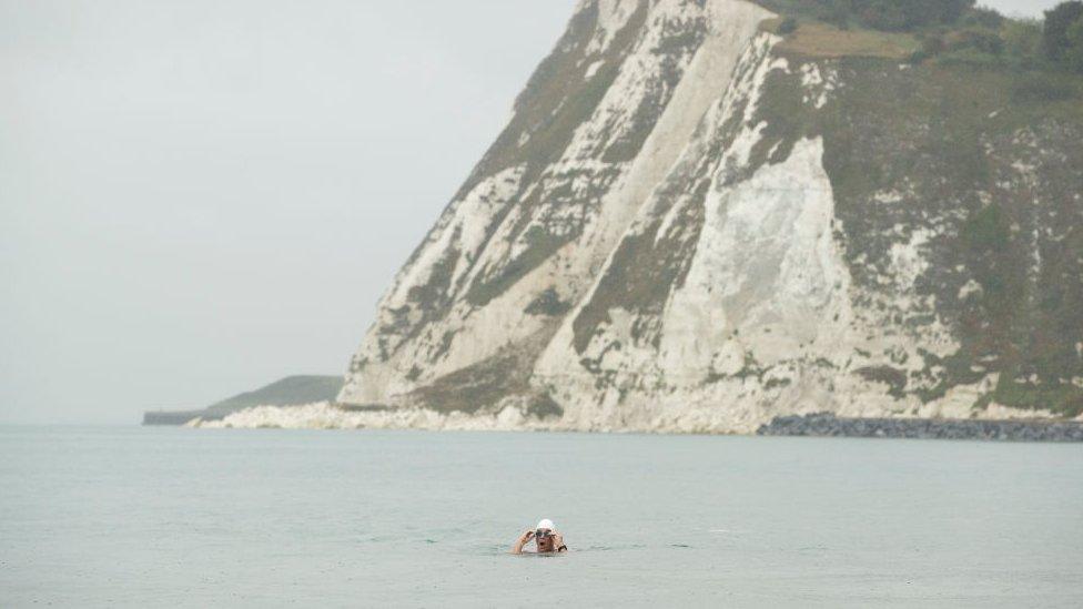 Lewis Pugh swimming near white cliffs