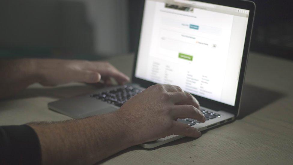 Stock photo of unidentified person on laptop