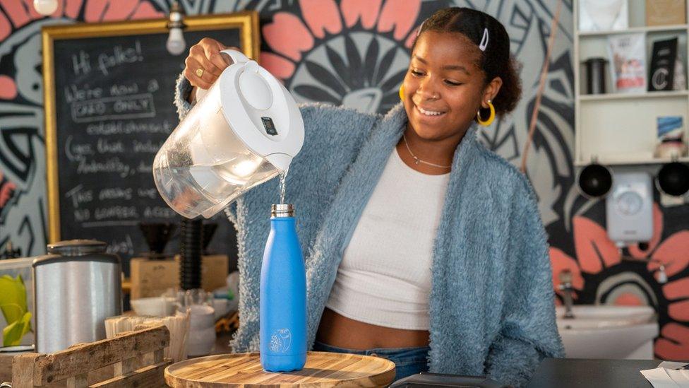 Woman refilling a water bottle