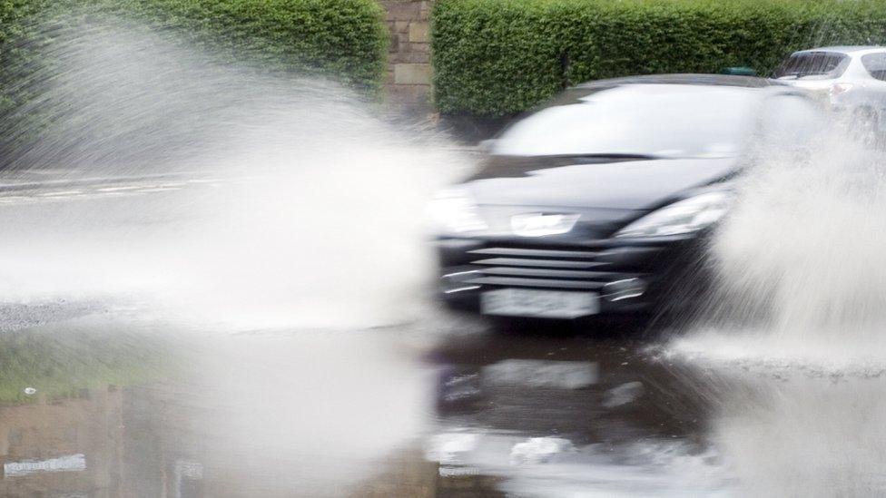 Car driving through puddle