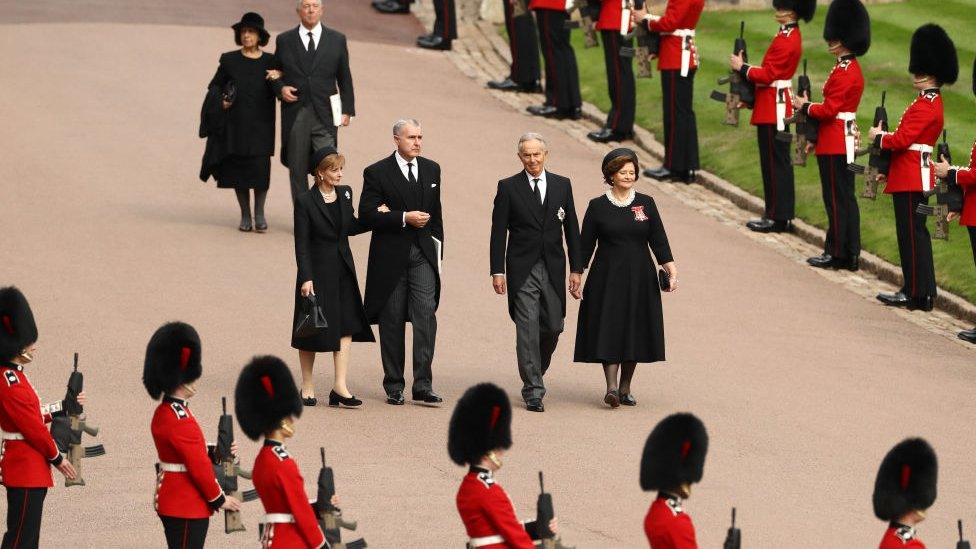 People walk into Windsor Castle, including Tony and Cherie Blair.