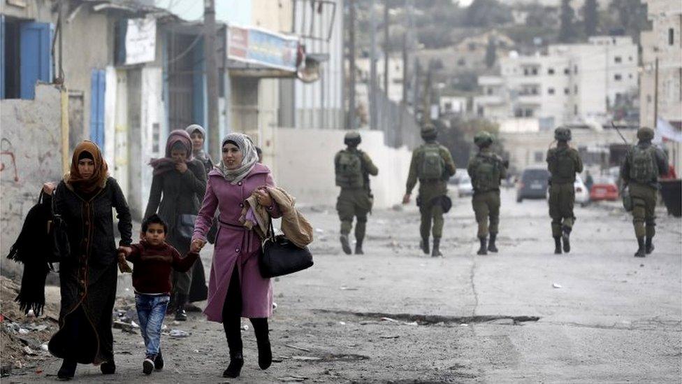 Palestinians and Israeli soldiers in Hebron