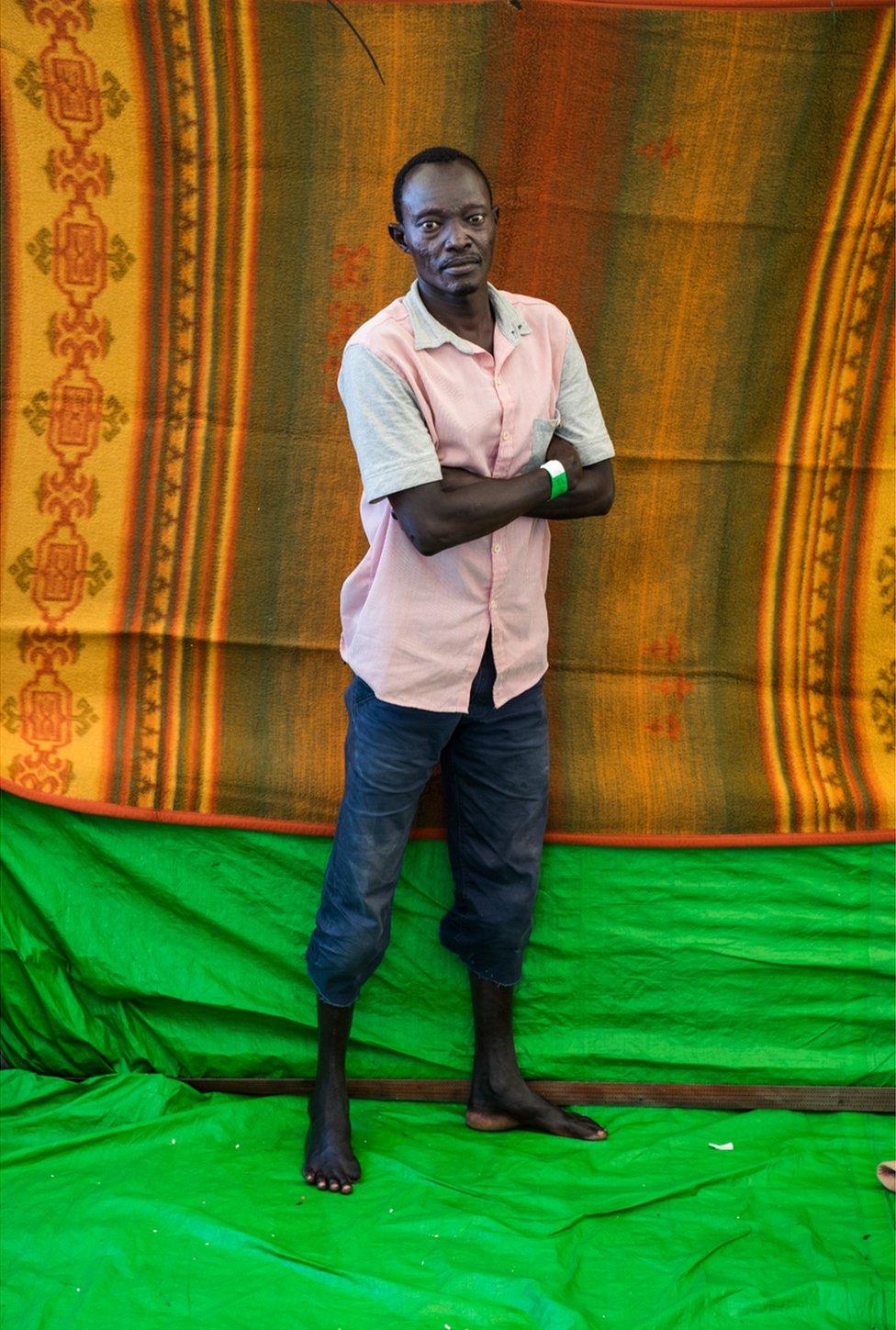 Abakamht Nour stands with his arms crossed