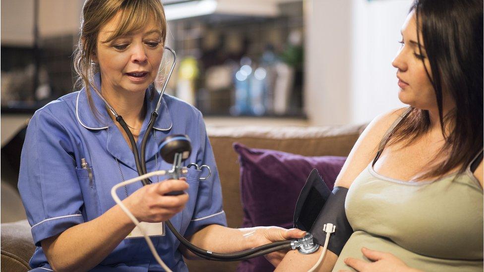 Maternity nurse with a patient