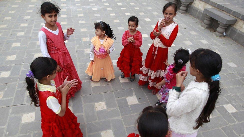 Yemeni displaced girls, who fled Saada province due to fighting between Shiite Huthi rebels and forces loyal to Yemen"s exiled President Abedrabbo Mansour Hadi, play on a street in San'aa's old city