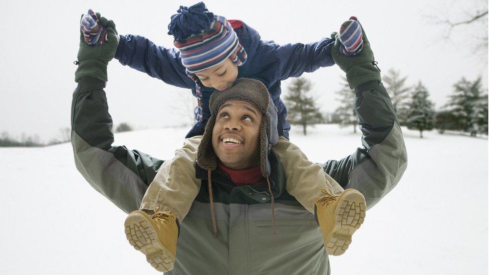 child-playing-in-snow-with-parent.