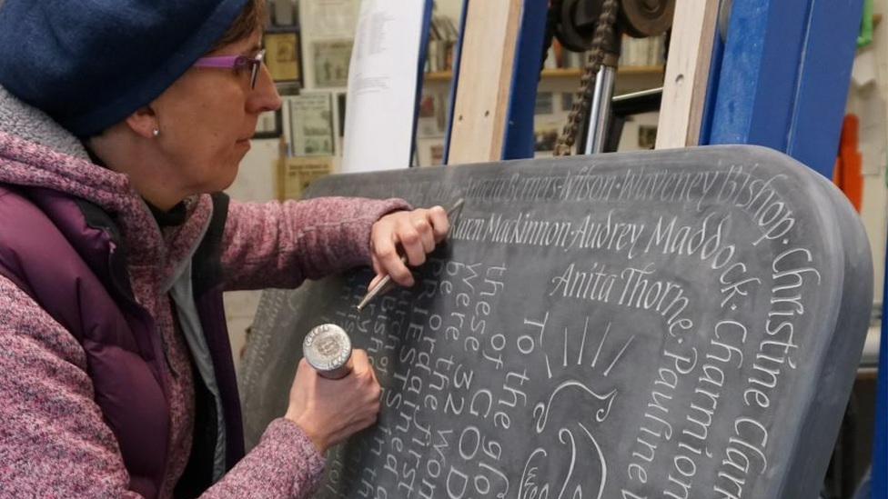 Robyn Golden-Hann carving the new slate plaque