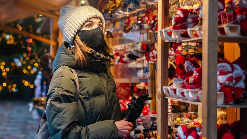 Woman in face mask at Christmas market