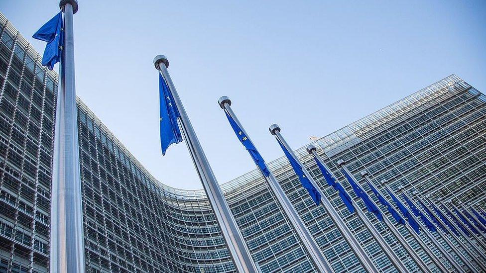 European flags in front of the European Commission headquarters at the Berlaymont Building in Brussels