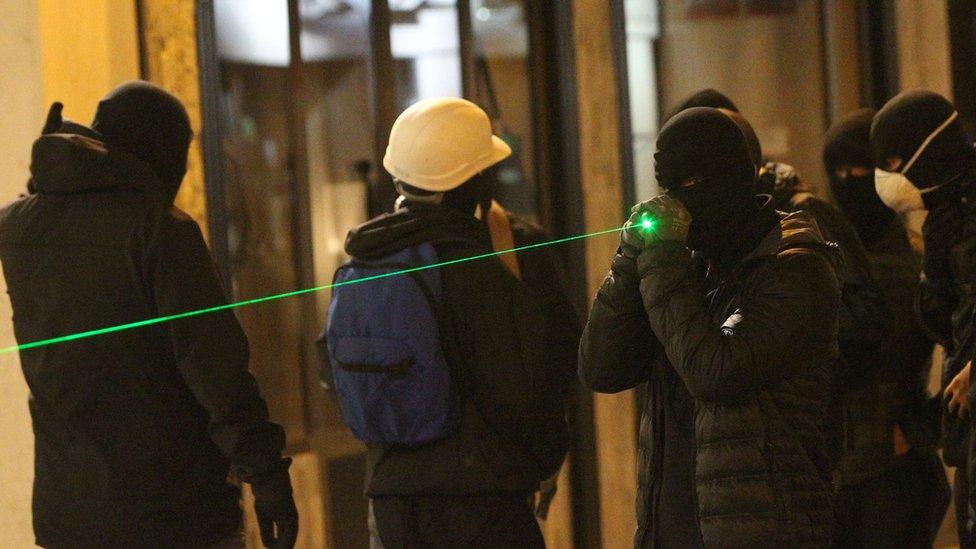 A protester holding a laser pen