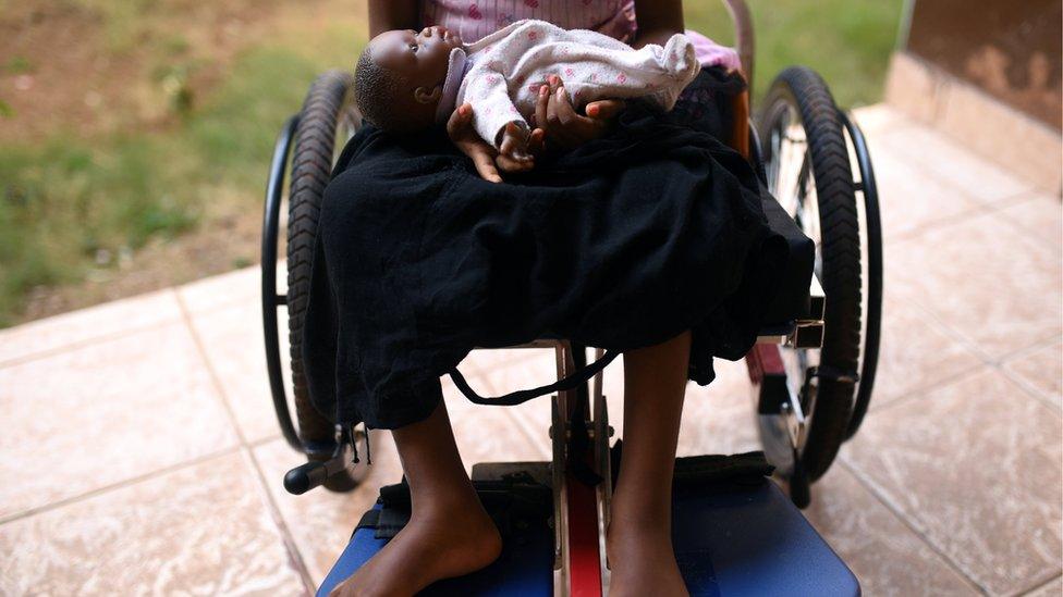 Five-year-old girl cradles a doll