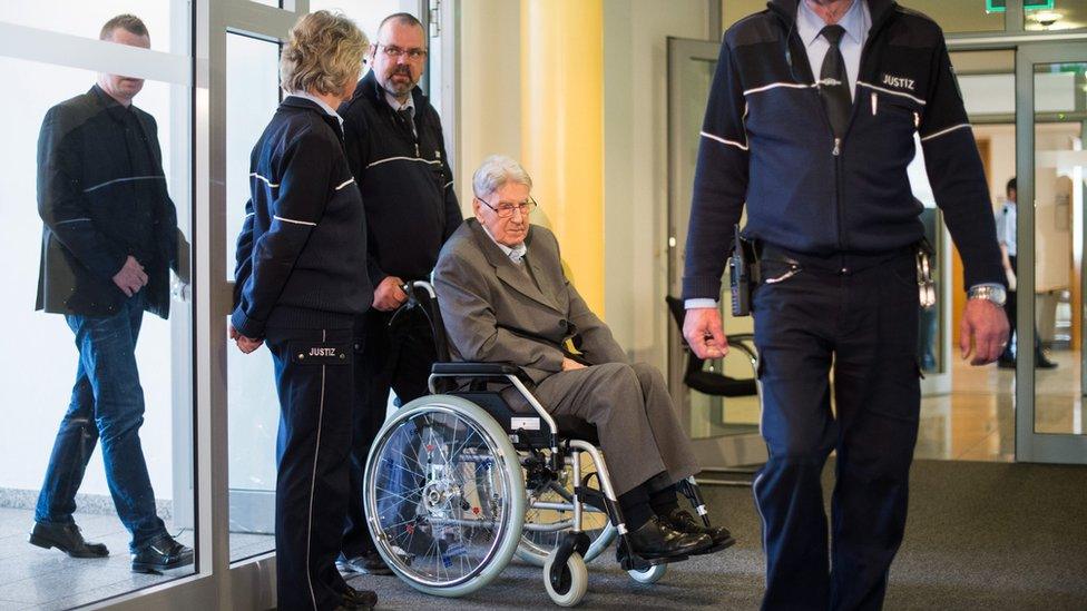 Reinhold Hanning (2-R) arrives for another day of his trial in Detmold, Germany (29 April 2016)