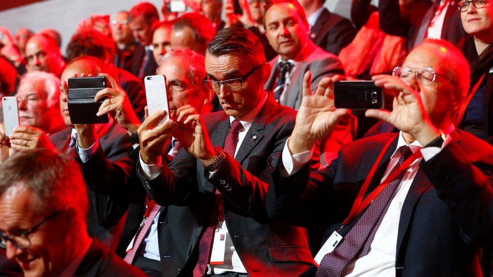 Guests use their mobile devices during the opening ceremony of the NEAT Gotthard Base Tunnel - 1 June 2016