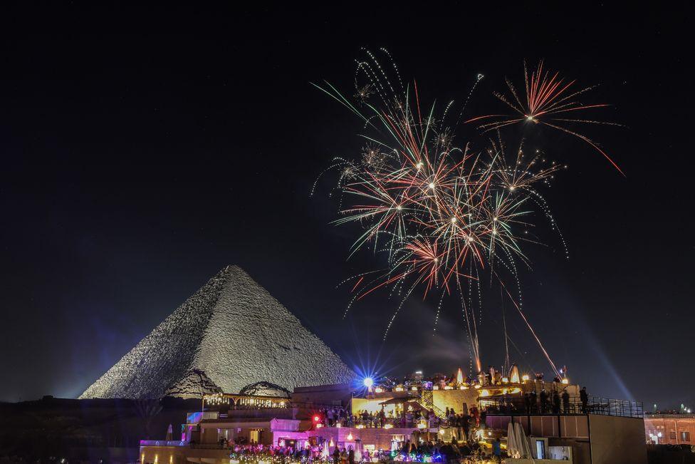 Fireworks light up the night sky to welcome the new year at the pyramids in Giza, Egypt - 1 January 2025. 