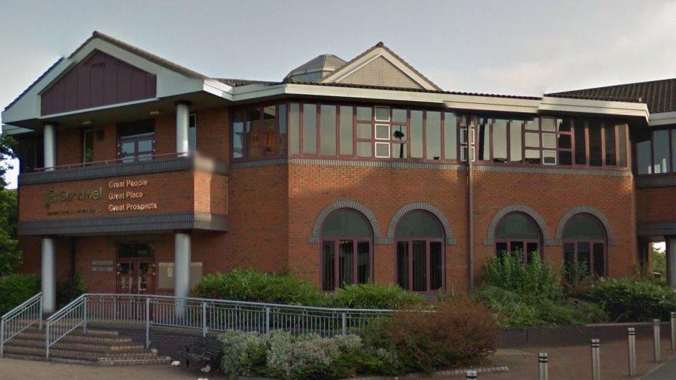 Sandwell Council House: a red-brick building with green plants around the exterior, and a sign saying "Great People, Great Place, Great Prospects"