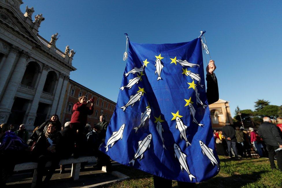 People take part in the "Sardine Movement" rally in Rome, 14 December