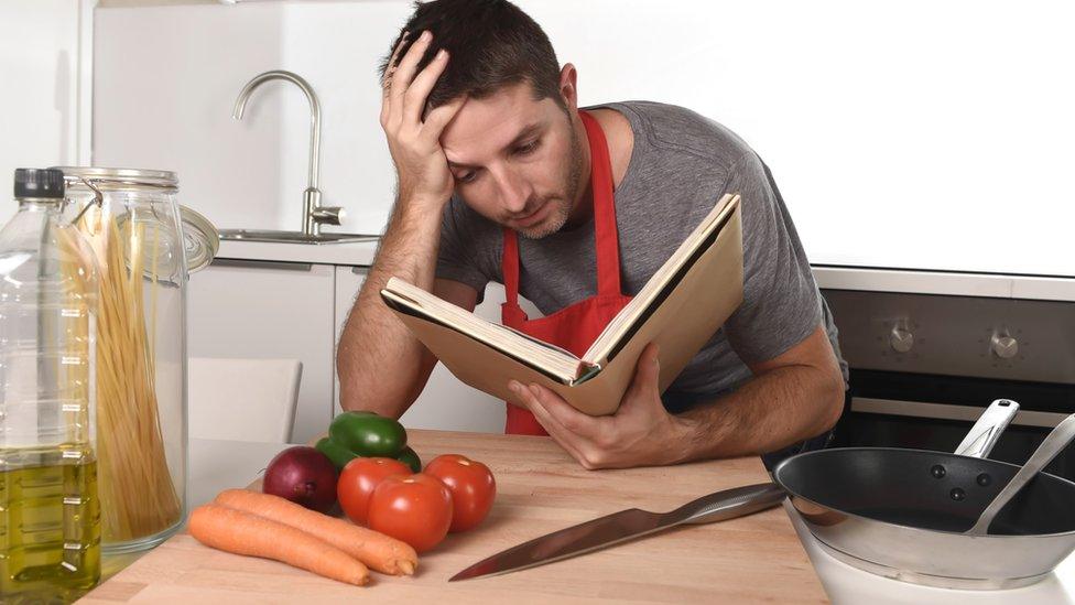 Man looking at cookbook