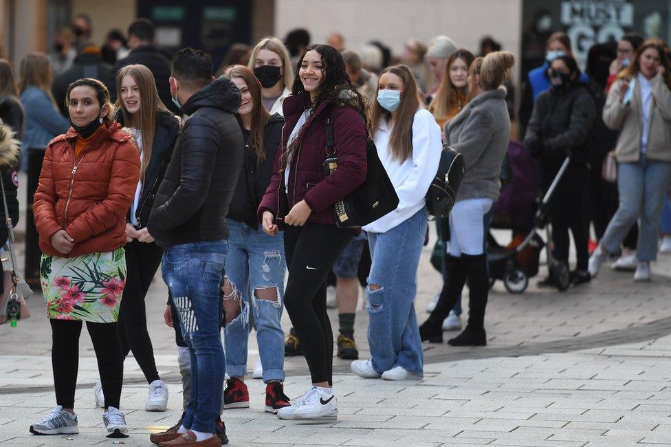 A group of customers queue outside Primark