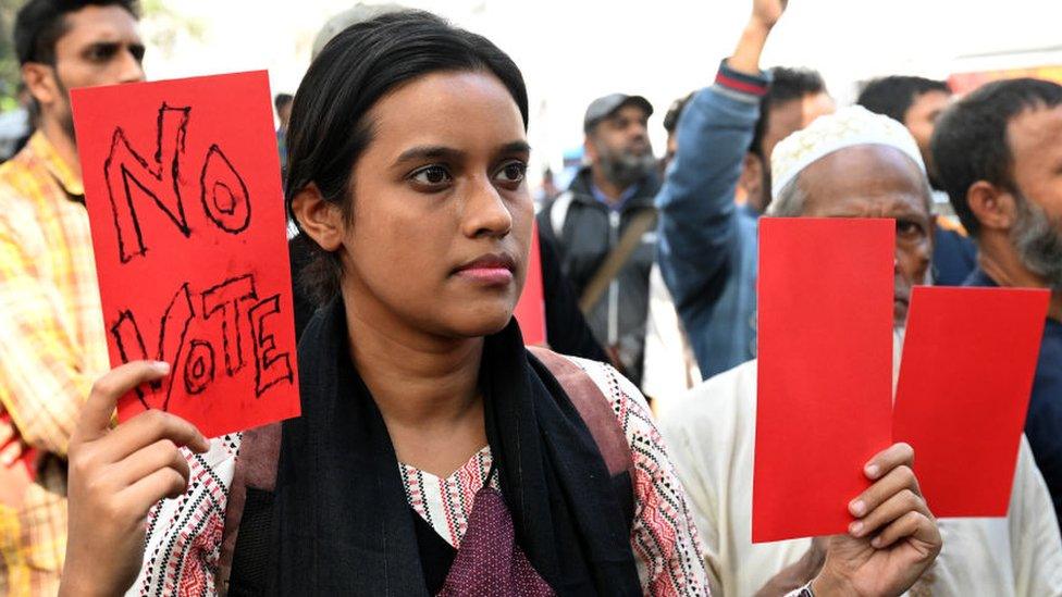 Activists from the Leftist Party's Alliance 'Ganatantra Mancha' are holding red cards as they participate in a rally to protest against the upcoming 2024 general elections in Dhaka, Bangladesh, on December 30, 2023.