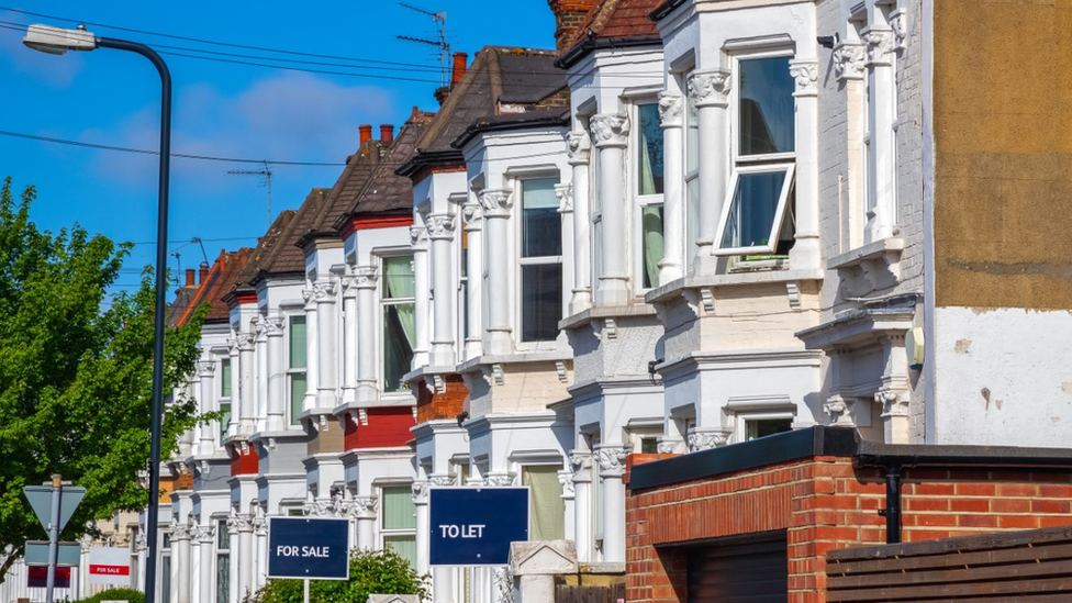 To let signs outside a street filled with houses