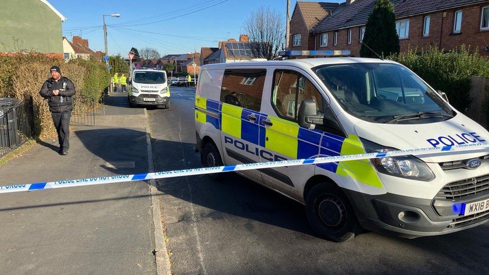 Ilminster Avenue, Bristol, with two police vans visible