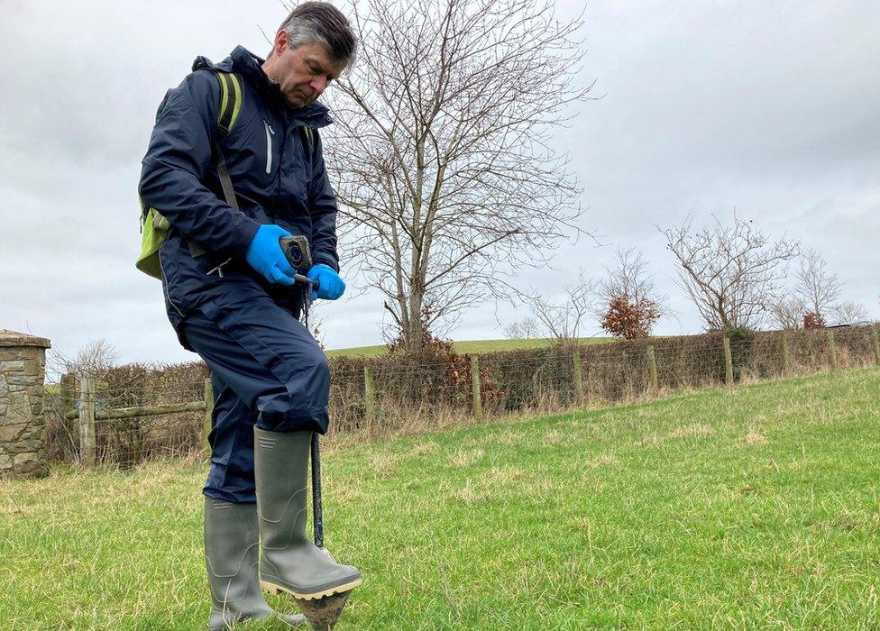 Man sampling soil