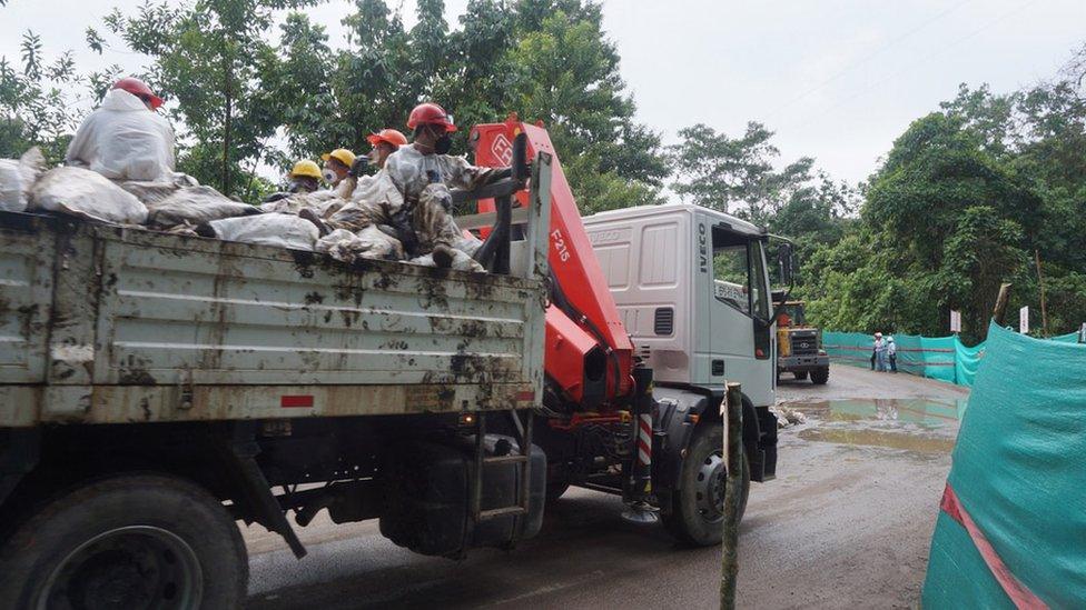 Sacks of contaminated rubbish are taken away